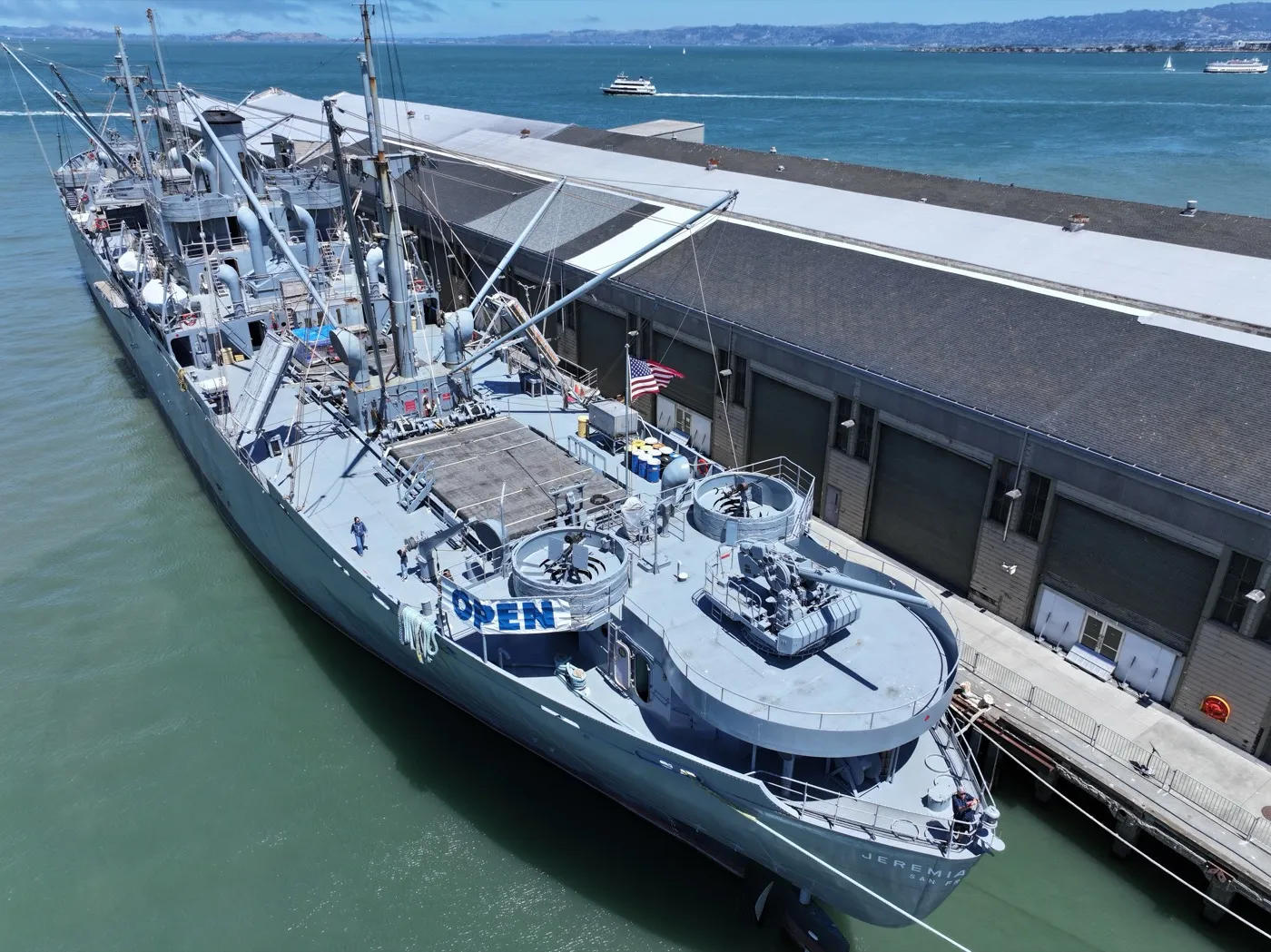 Stern view showing guns, American flag, and OPEN banner