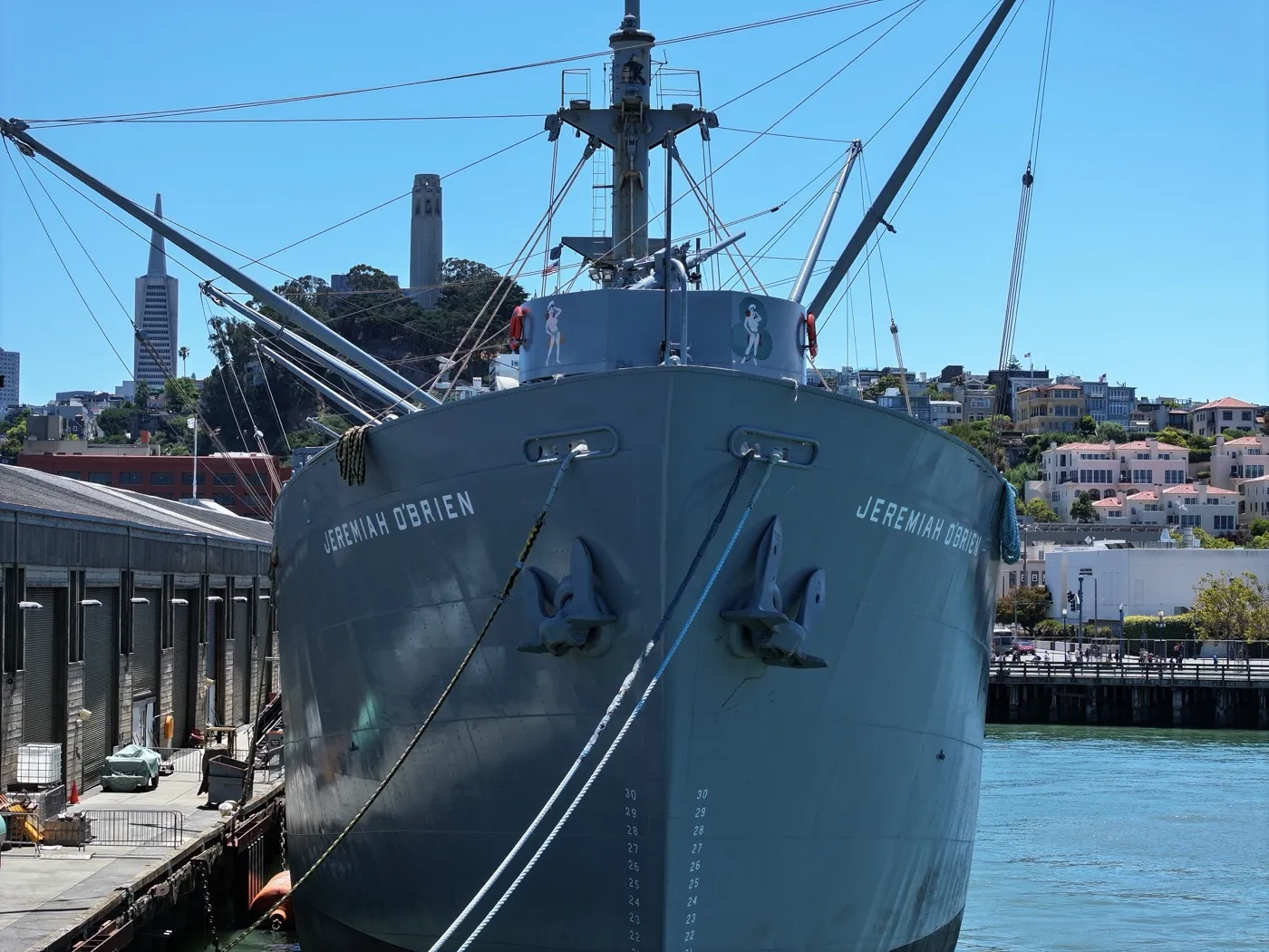 Dramatic bow-on view of SS Jeremiah O'Brien with Coit Tower behind